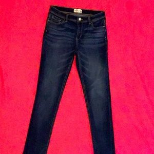 Women’s jeans that are dark blue.